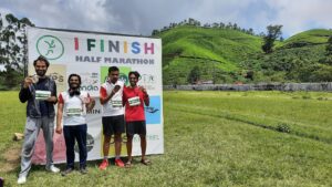 20220529_111202 -- Aditya, Anal, Me, And Girish after finishing the half-marathon. Anal was last to finish. He read a few articles while running. My legs were sore after the running.